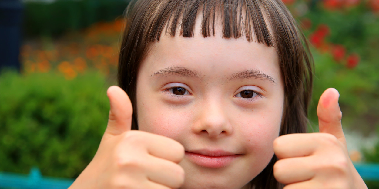 A school girl showing her thumbs up